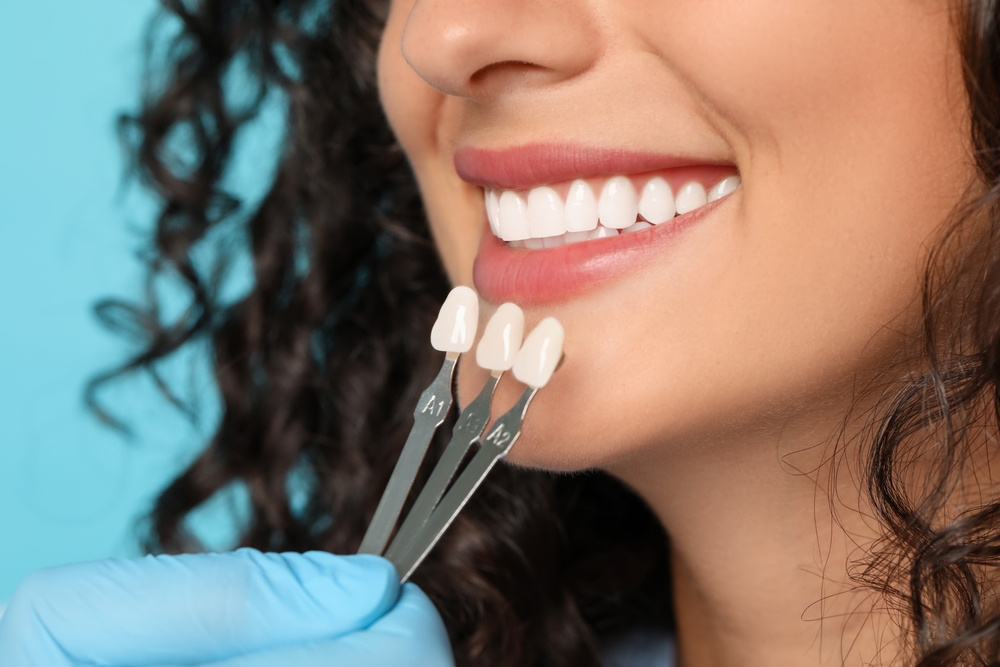 Doctor,Checking,Young,Woman's,Teeth,Color,On,Light,Blue,Background,